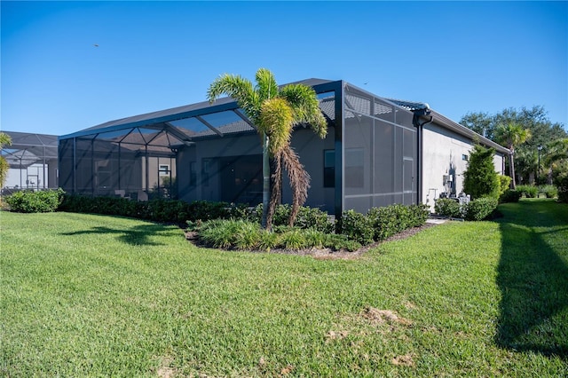 view of property exterior with glass enclosure and a yard