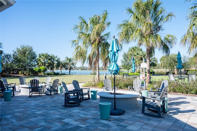 view of patio featuring a fire pit and a water view