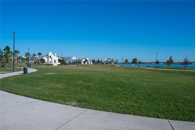 view of community featuring a yard and a water view