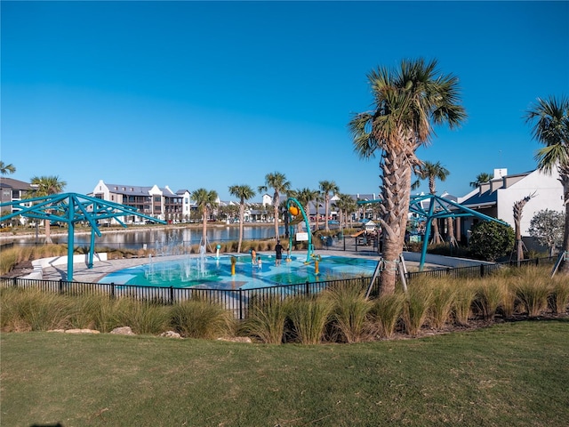 view of swimming pool with a water view and a yard