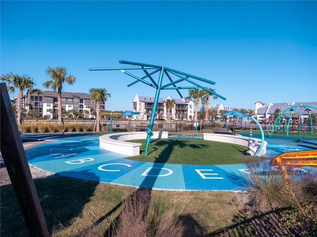 view of property's community with a playground and a yard