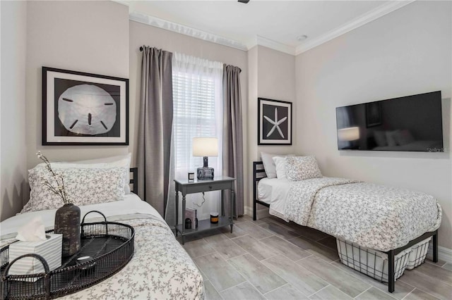 bedroom with light wood-type flooring and crown molding