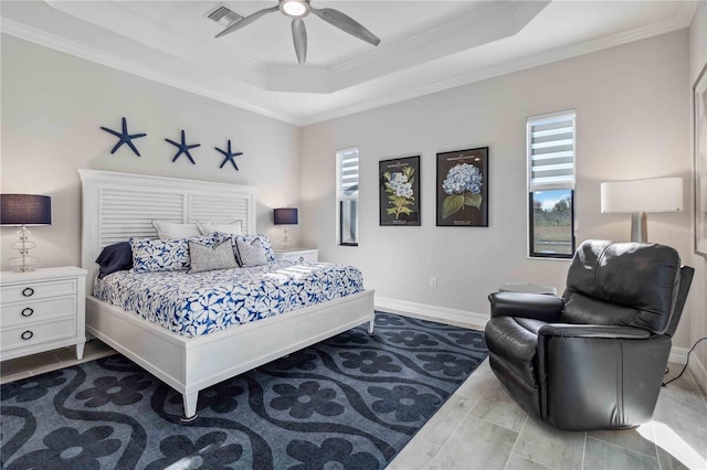 bedroom with ceiling fan, a raised ceiling, and crown molding