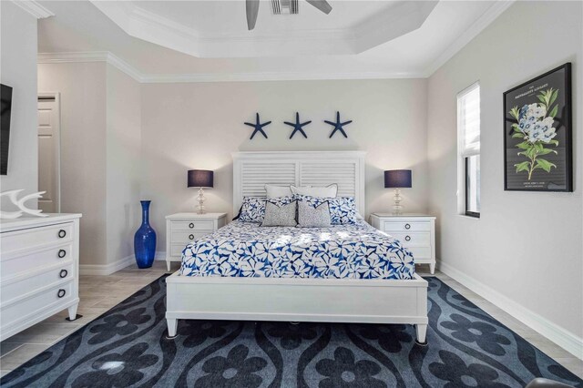 bedroom featuring a raised ceiling, ceiling fan, and ornamental molding