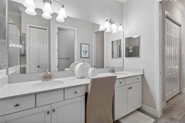 bathroom featuring tile patterned flooring, vanity, and a notable chandelier