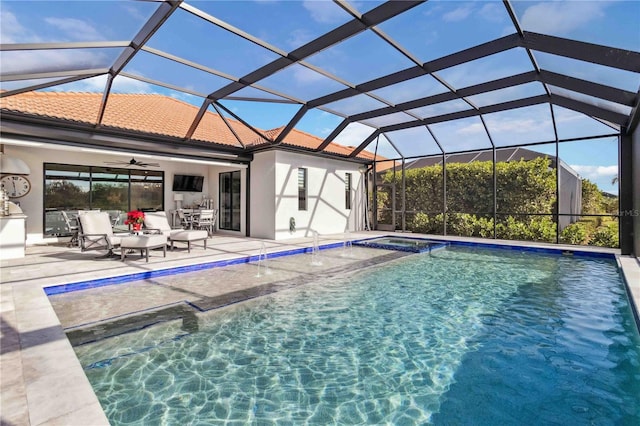 view of pool with ceiling fan, a patio area, a lanai, and an outdoor living space