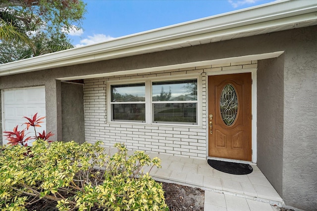 doorway to property featuring a garage