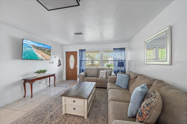 tiled living room featuring plenty of natural light and a textured ceiling