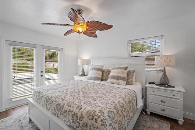 bedroom featuring access to outside, multiple windows, and dark hardwood / wood-style flooring