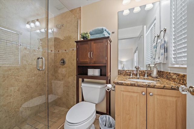 bathroom with vanity, toilet, and walk in shower