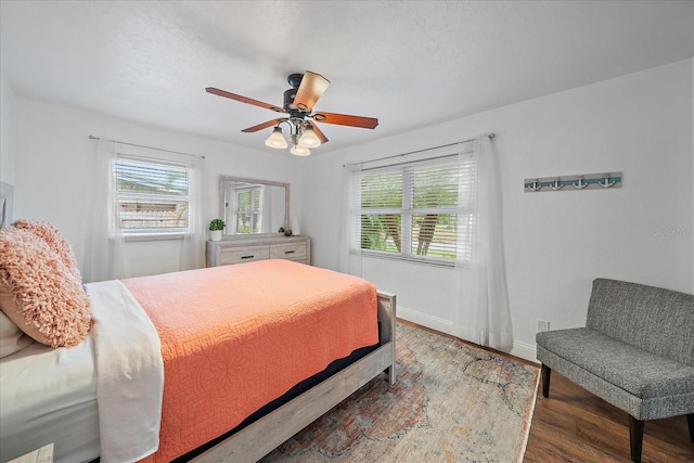 bedroom with hardwood / wood-style flooring and ceiling fan