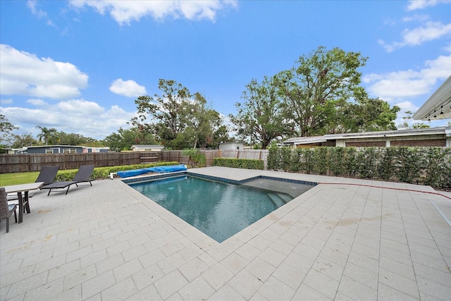 view of swimming pool with a patio