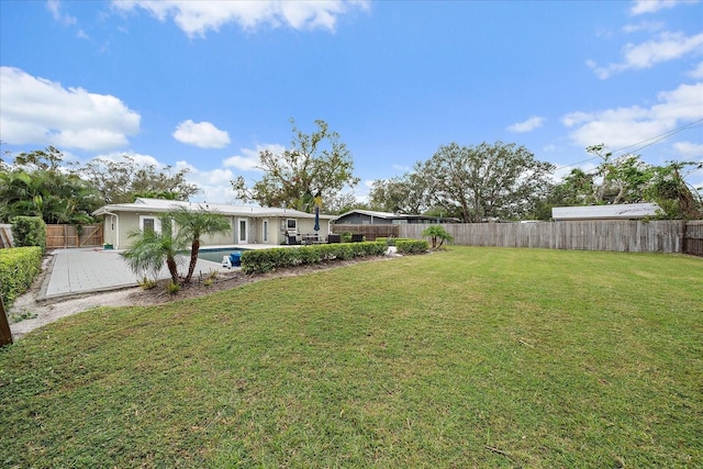 view of yard featuring a fenced in pool and a patio