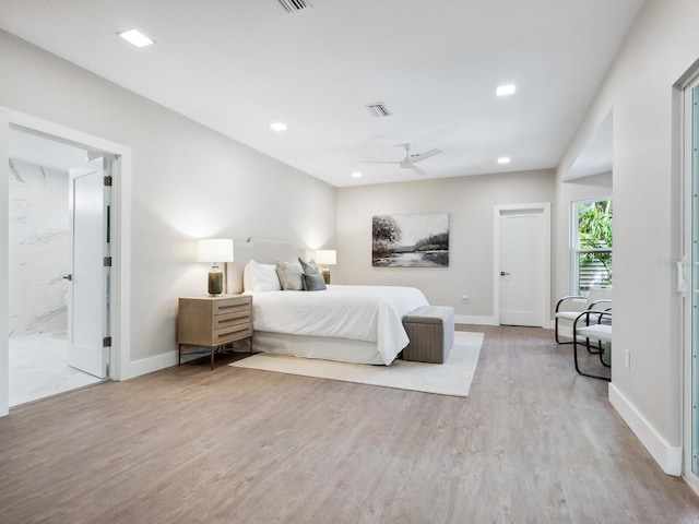 bedroom with ensuite bath, ceiling fan, and hardwood / wood-style flooring