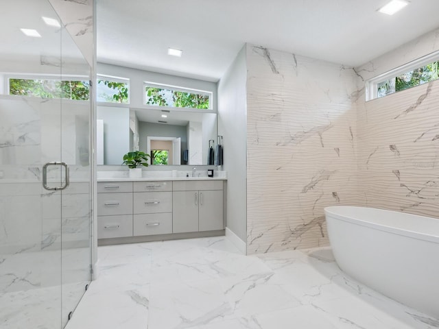 bathroom with vanity and shower with separate bathtub