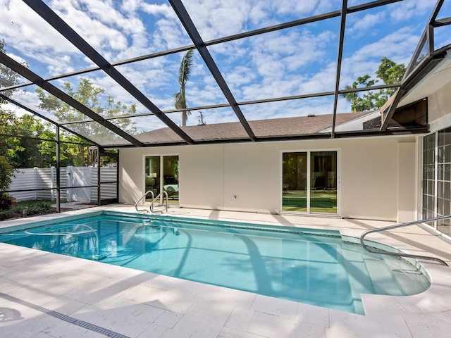 view of swimming pool featuring a lanai and a patio