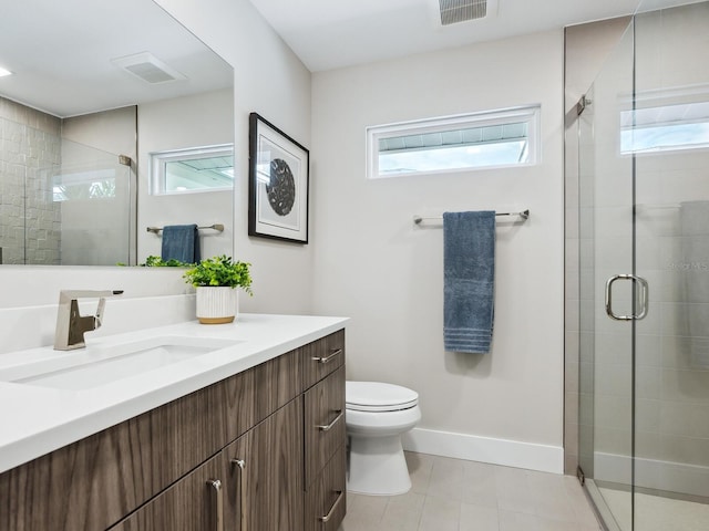 bathroom featuring tile patterned floors, plenty of natural light, toilet, and vanity