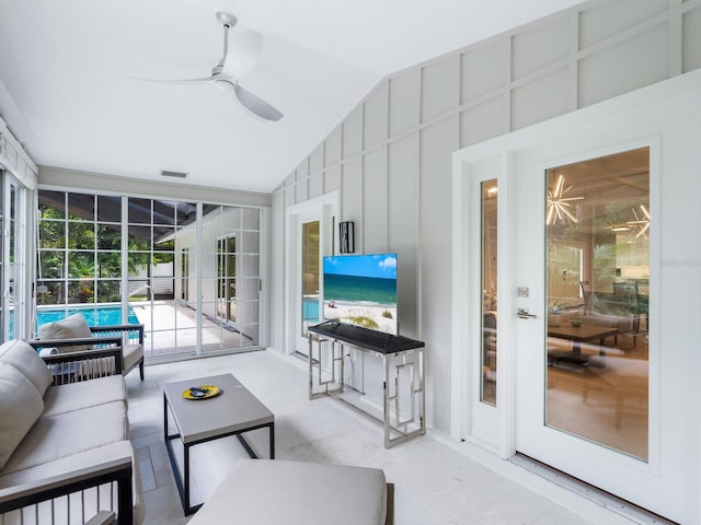 living room with ceiling fan and lofted ceiling