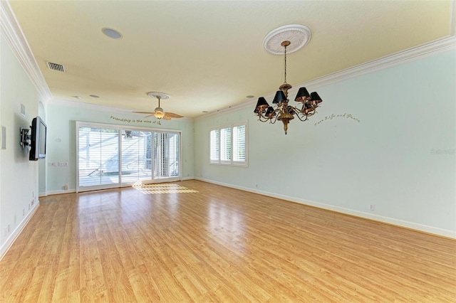 empty room featuring ornamental molding, a healthy amount of sunlight, ceiling fan with notable chandelier, and light hardwood / wood-style floors