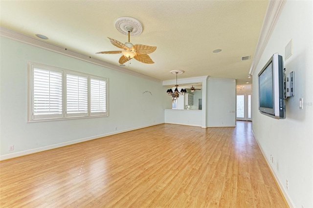 unfurnished living room with ceiling fan with notable chandelier, light hardwood / wood-style floors, crown molding, and a wealth of natural light