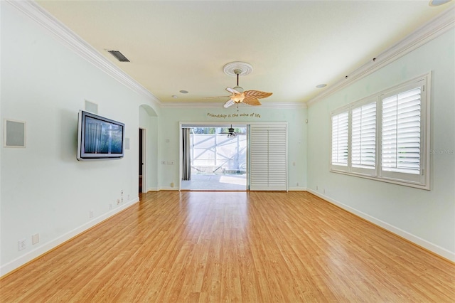 unfurnished living room featuring light hardwood / wood-style floors, ceiling fan, and crown molding