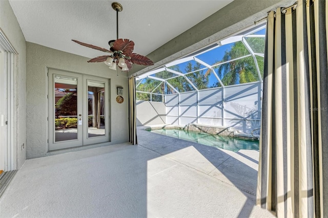 view of patio / terrace with ceiling fan, a lanai, and french doors