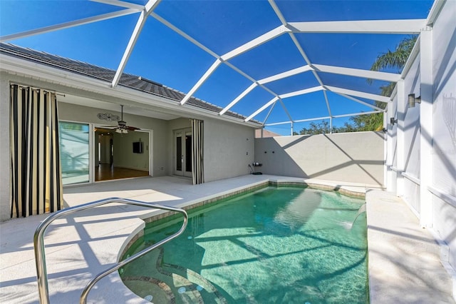 view of pool featuring a lanai, ceiling fan, and a patio