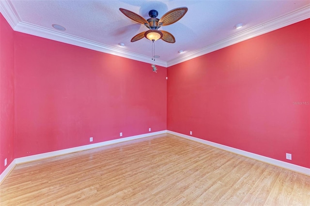 spare room featuring crown molding, wood-type flooring, and a textured ceiling