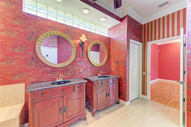 bathroom featuring hardwood / wood-style floors, vanity, plenty of natural light, and crown molding