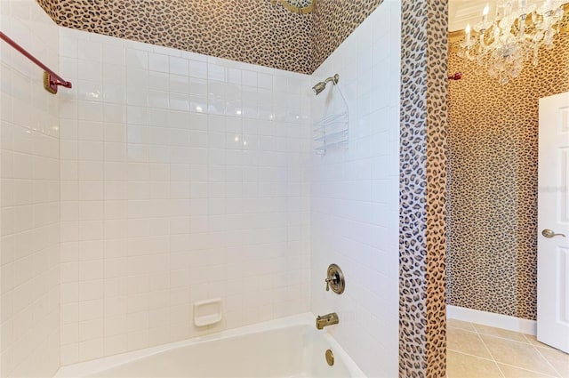 bathroom featuring tile patterned flooring and tiled shower / bath