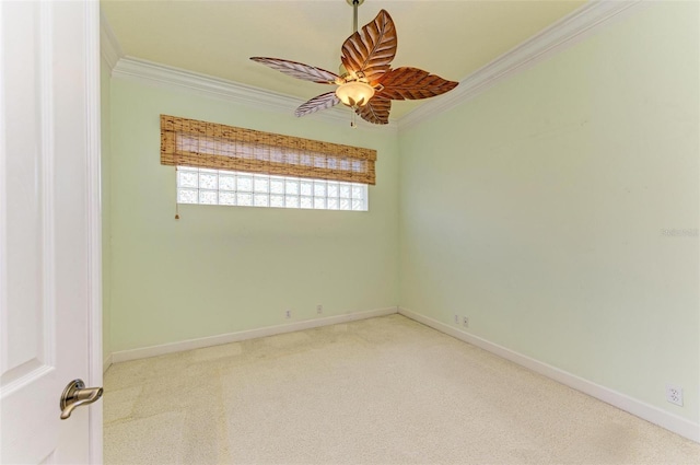 carpeted spare room with ceiling fan and ornamental molding