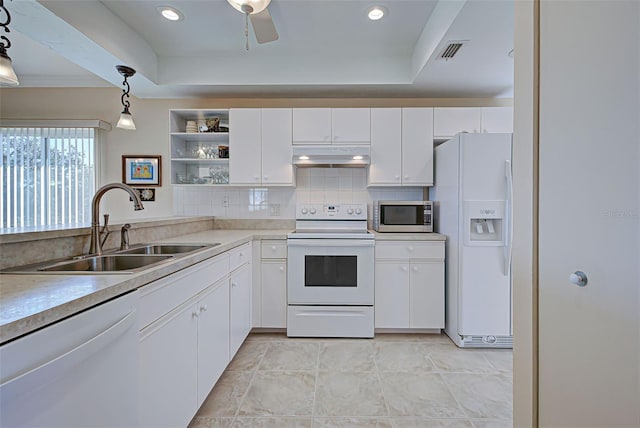 kitchen featuring sink, a raised ceiling, pendant lighting, white appliances, and white cabinets