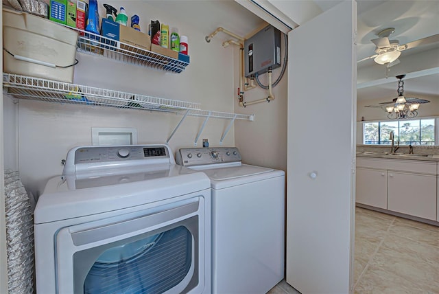 clothes washing area with sink, ceiling fan, washing machine and dryer, light tile patterned floors, and water heater