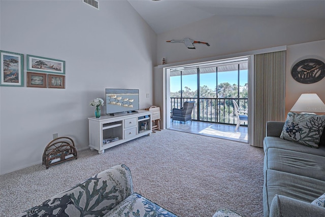 carpeted living room featuring vaulted ceiling