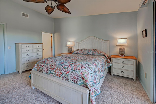 carpeted bedroom with ceiling fan and vaulted ceiling