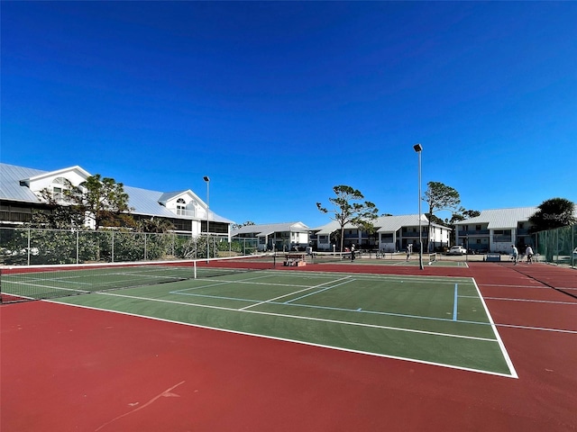 view of tennis court featuring basketball court