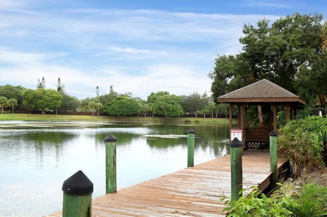 view of dock with a gazebo and a water view