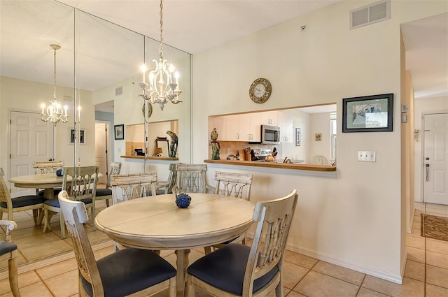 8755 Olde Hickory Ave Unit 7101, Sarasota, FL 34238 - dining area with a chandelier, light tile patterned floors, and a towering ceiling