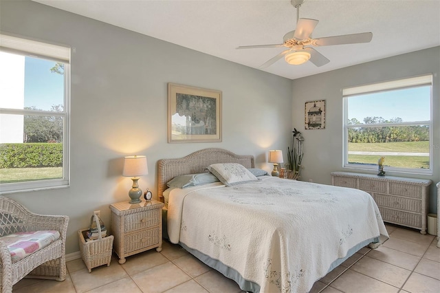 8755 Olde Hickory Ave Unit 7101, Sarasota, FL 34238 - bedroom with light tile patterned flooring, multiple windows, and a ceiling fan