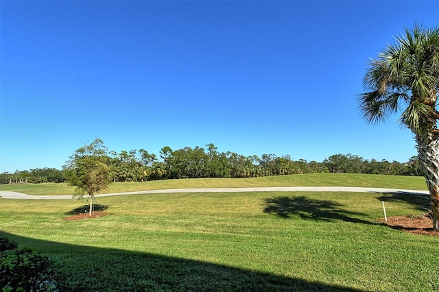 8755 Olde Hickory Ave Unit 7101, Sarasota, FL 34238 - view of property's community featuring a yard, golf course view, and view of wooded area