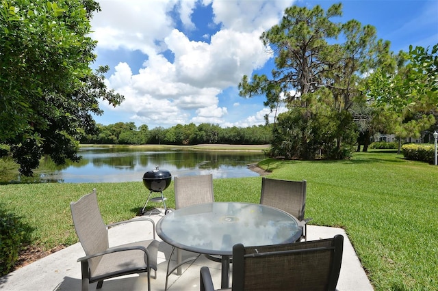 8755 Olde Hickory Ave Unit 7101, Sarasota, FL 34238 - view of patio / terrace with a water view, outdoor dining area, and area for grilling