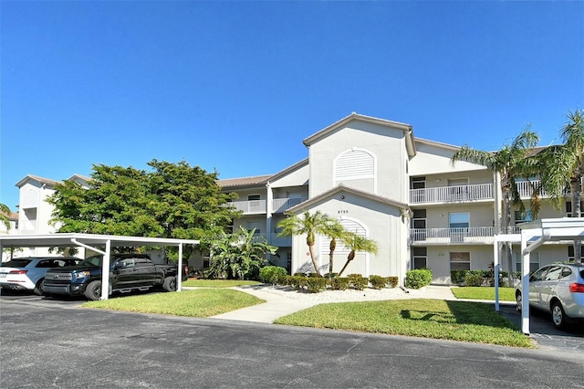 8755 Olde Hickory Ave Unit 7101, Sarasota, FL 34238 - view of building exterior featuring covered parking