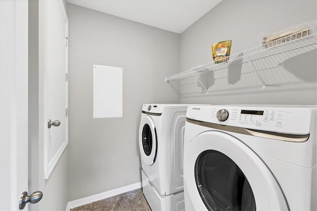 clothes washing area with washing machine and dryer