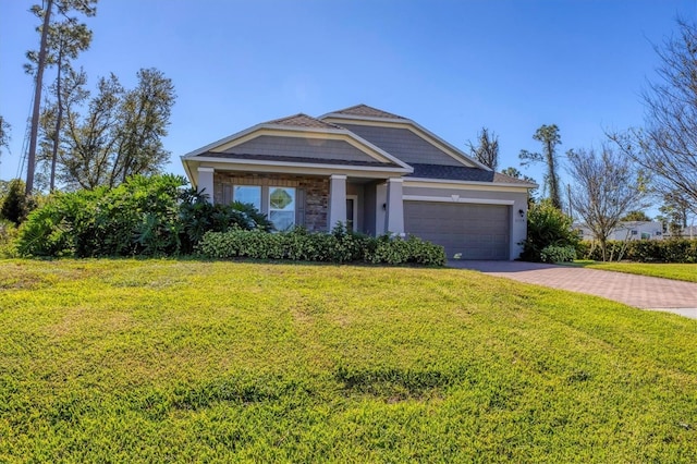 view of front of home with a front lawn and a garage