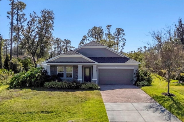 view of front of house with a front yard and a garage