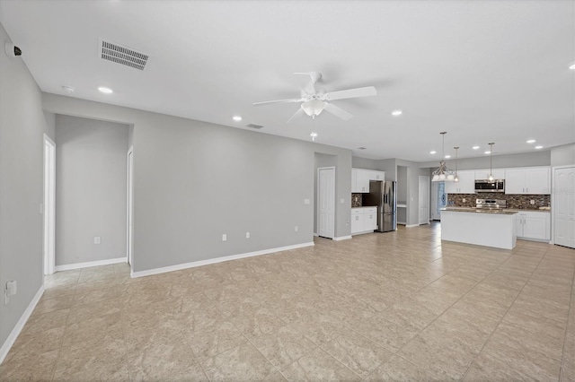 unfurnished living room featuring ceiling fan