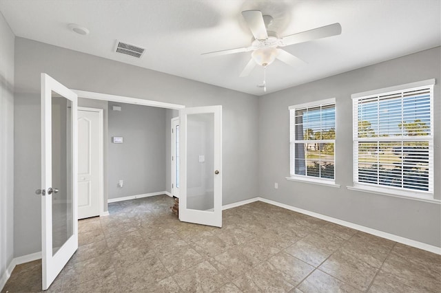 unfurnished bedroom with ceiling fan and french doors