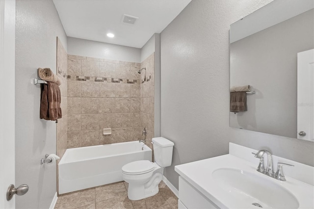 full bathroom featuring tile patterned flooring, vanity, toilet, and tiled shower / bath