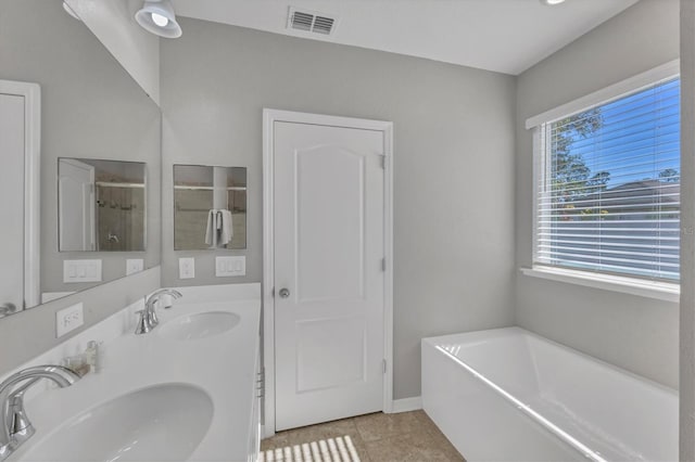 bathroom featuring plus walk in shower, tile patterned flooring, and vanity