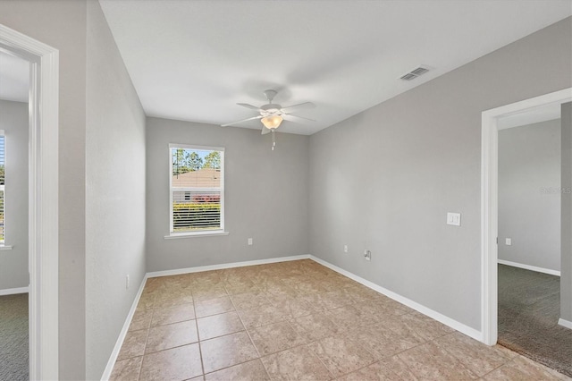 empty room featuring light tile patterned floors and ceiling fan